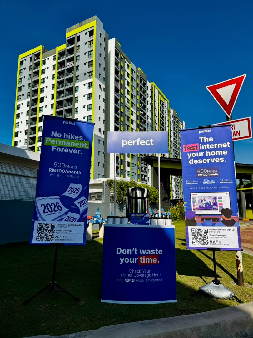 Perfect coverage campaign booth and banners set up against high-rise towers