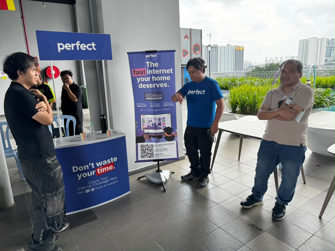 Residents chatting with the Perfect team at an outdoor activation booth